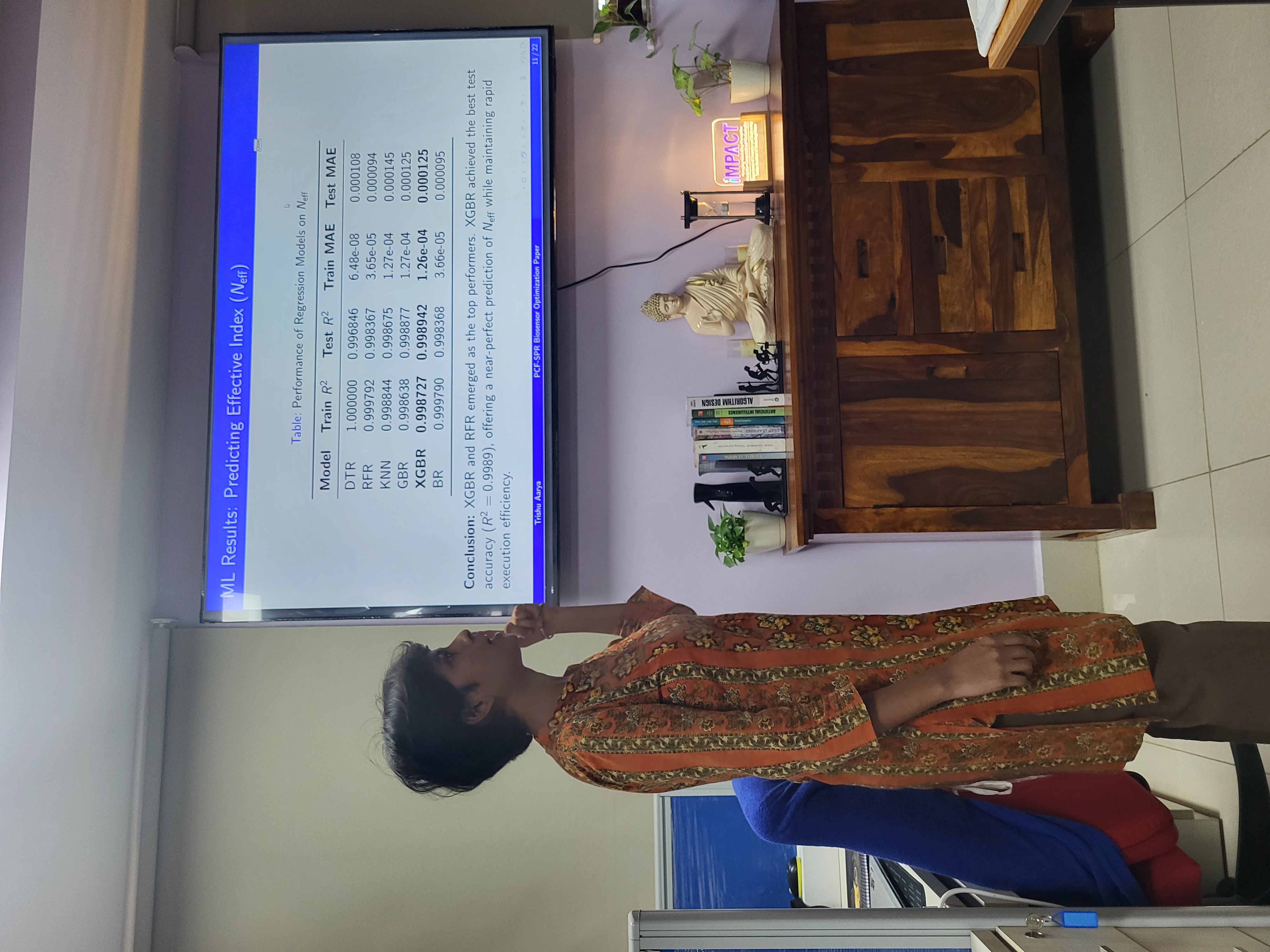 Researcher presenting machine learning results on a lab screen