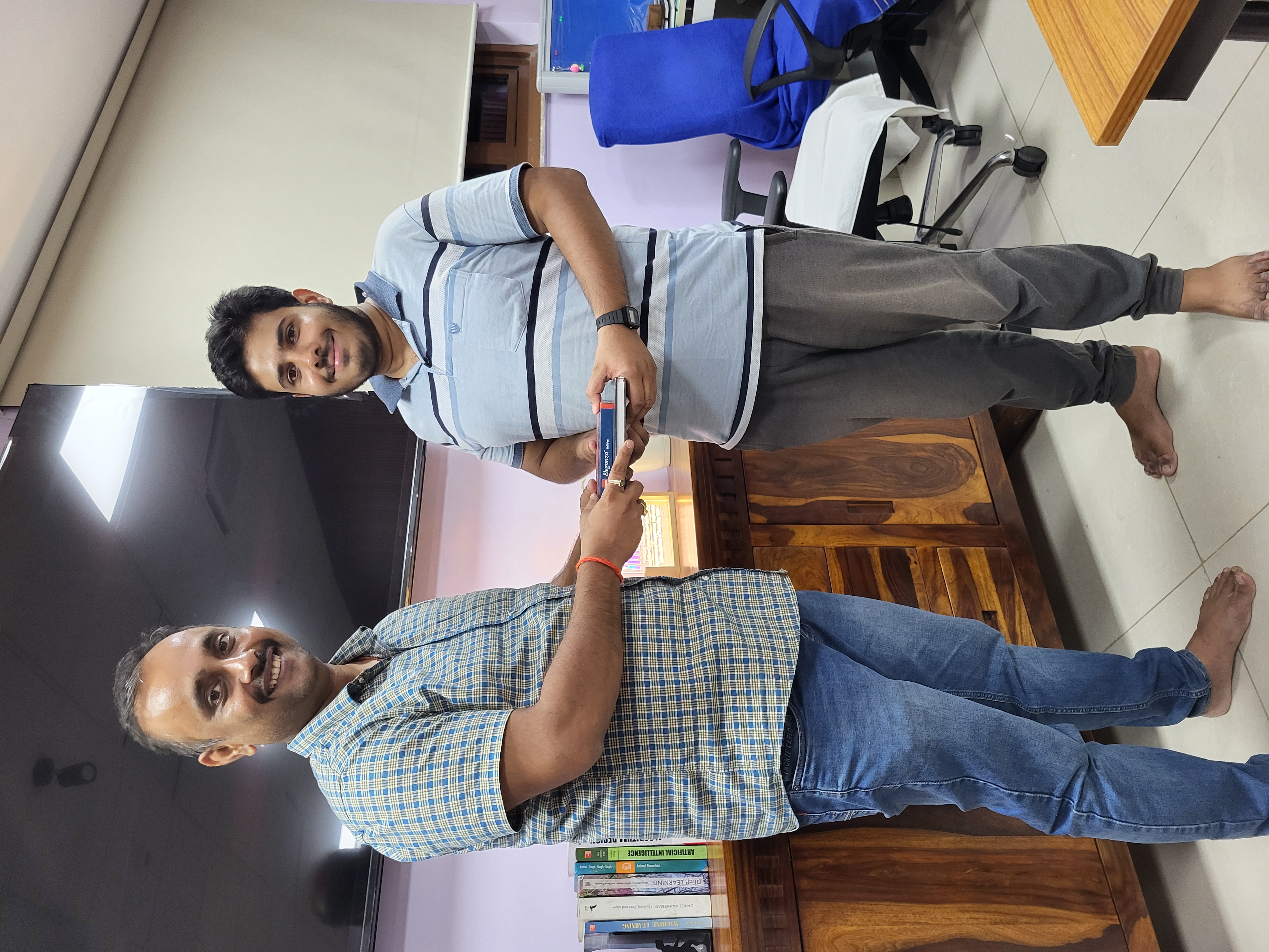 A researcher receiving a book as recognition