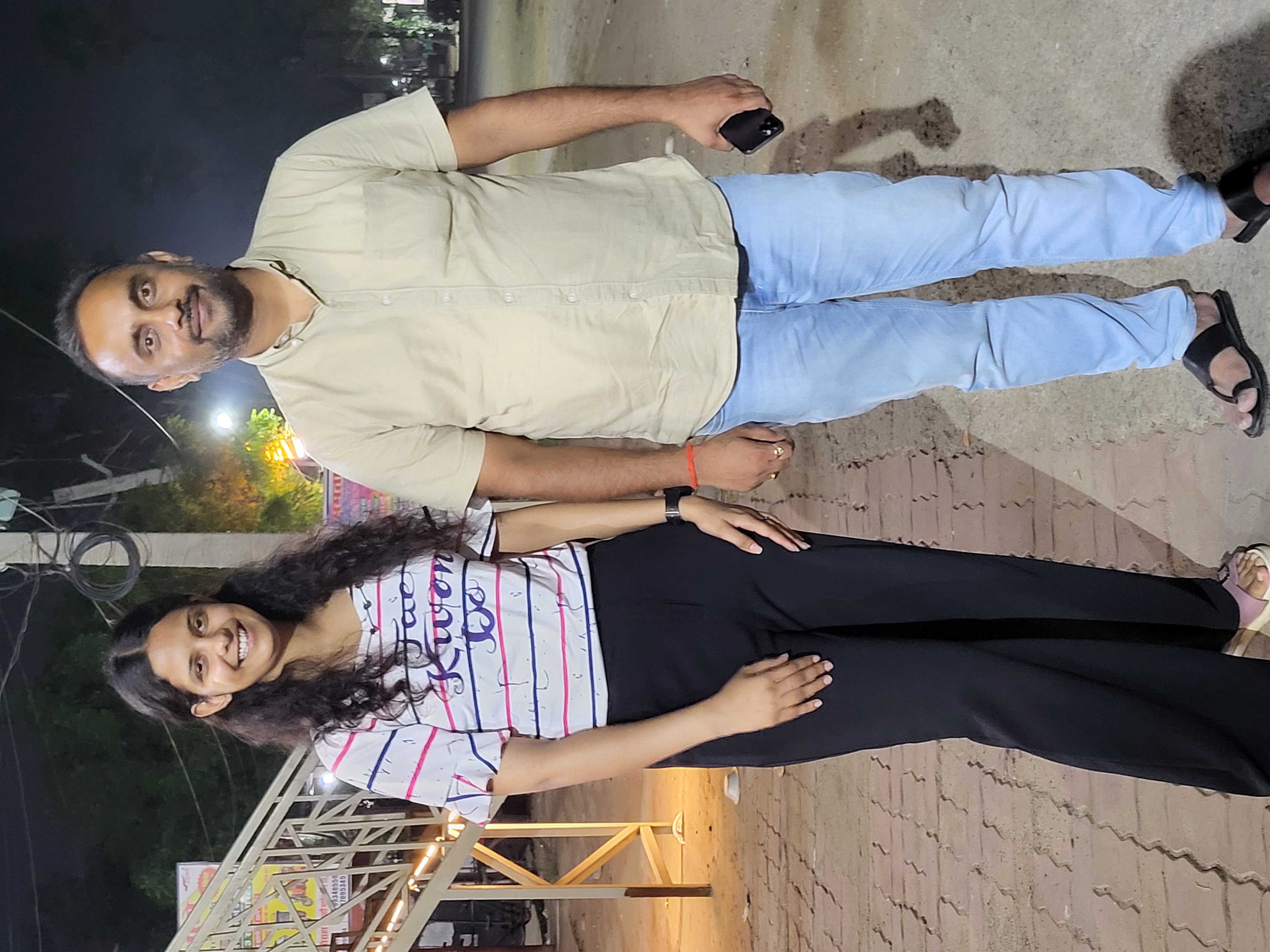 Dr. Rishav Singh with a lab researcher outdoors in the evening